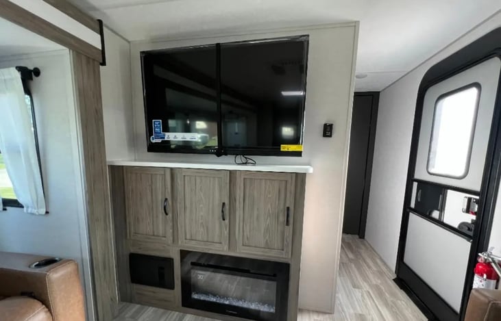 Entertainment center. 50” TV with soundbar and electric fireplace