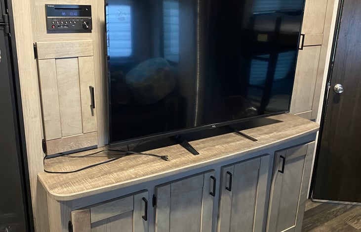 Entertainment center - plenty of storage - small hanging closet to the right  - bathroom entrance and bunk beds to the right