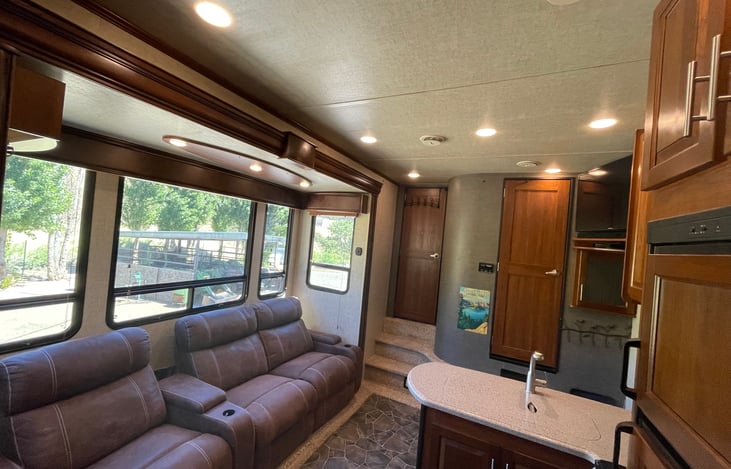 Living room/Kitchen windows have wooden louvered shades(open).