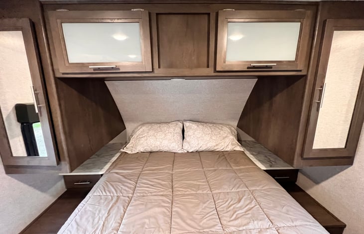 Queen walk around bed with memory foam mattress.  Storage above the bed.  Hanging space, drawer, nightstand on each side.