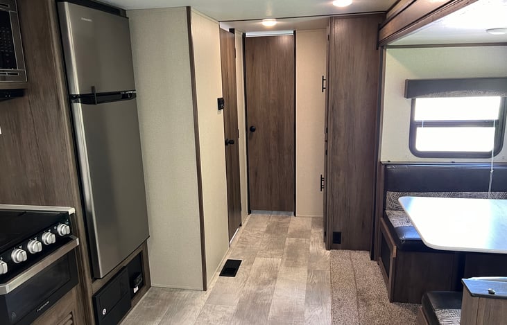 Looking down the hallway. Bathroom to the left, bunk room straight ahead and pantry to the right.