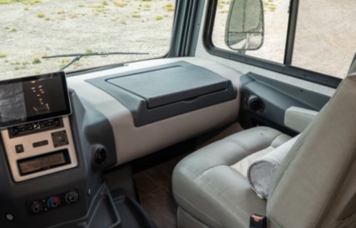 passenger seat features lumbar pillow and pop up table for eating or working on the road or when parked.