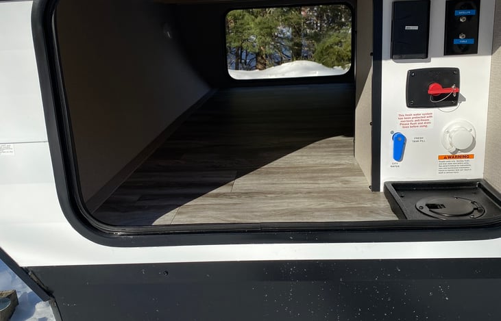 Front storage bin, goes completely threw front of camper