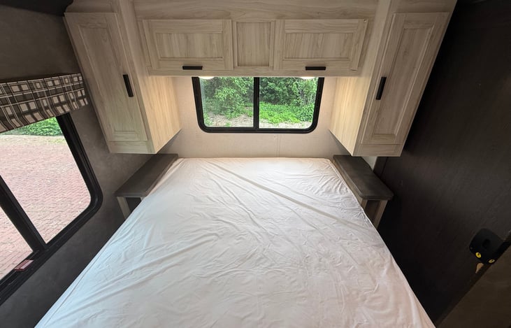Showing the cabinets above the bed. On both sides of the bed are 110v outlets for you to plug your CPAP machine and phones.