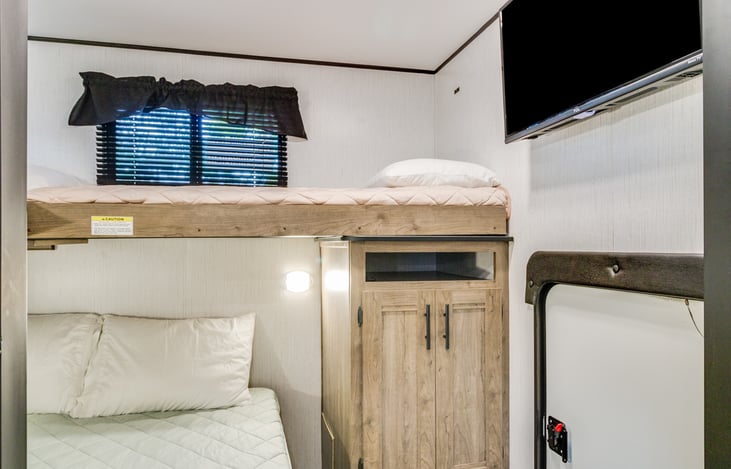 Bunk room showing tv and back door area.