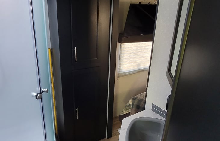 Linen closet in bathroom.