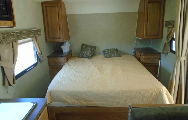 Queen bed pulled down. Privacy curtain blocks off this roomy area