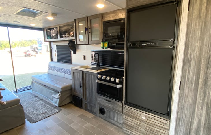 Kitchen.  Gas stove, oven, fridge, single sink, microwave.