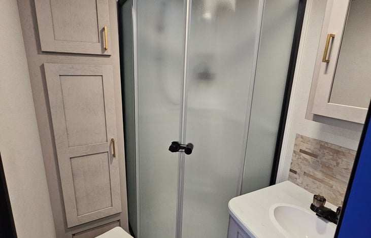 Everything you need, right where you need it — full bathroom with built-in storage