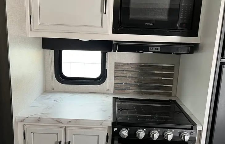 The kitchen is stocked with 8 place settings, silverware, cups, pots, pans, cutting board, knives, kitchen towels, keurig with reusable pods (or bring your own), toaster & blender.