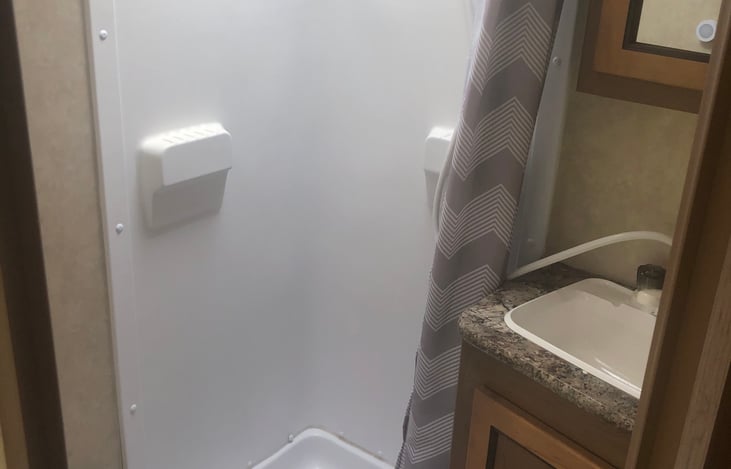 Shower and sink area.  Toilet is right NeXT to shower