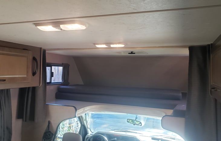 Bed above cab with cushion removed to allow space for getting into and out of drivers seat!