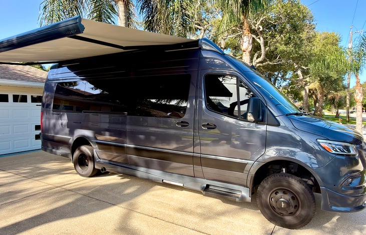 Power awning, touch a button and it opens automatically.  Sit backhand relax in the shade with the included among chairs, camping table and outdoor rug