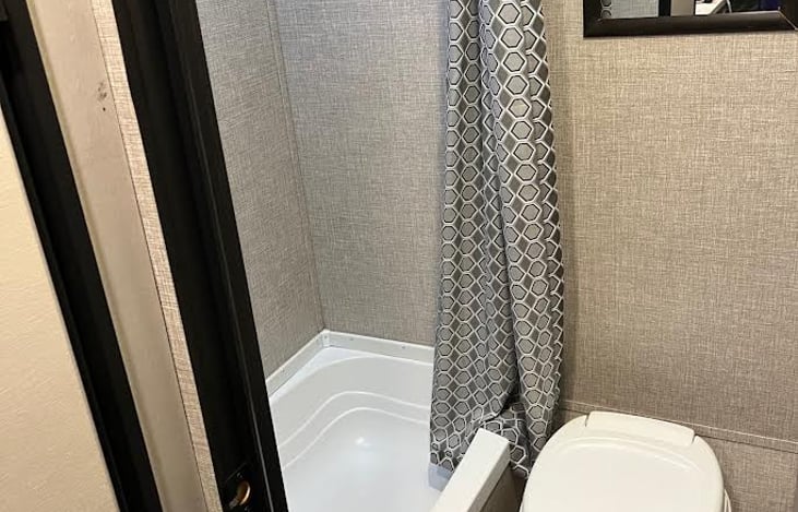 Tub/Shower combo next to toilet allows for shoulder room for the big guys