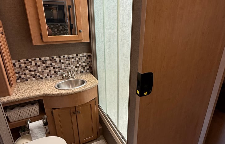 Bathroom includes shower, toilet and sink. Stocked with linens and essential toiletries.
