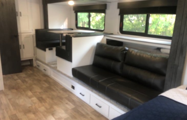 Full slide out with couch and table. Both can be converted to beds.