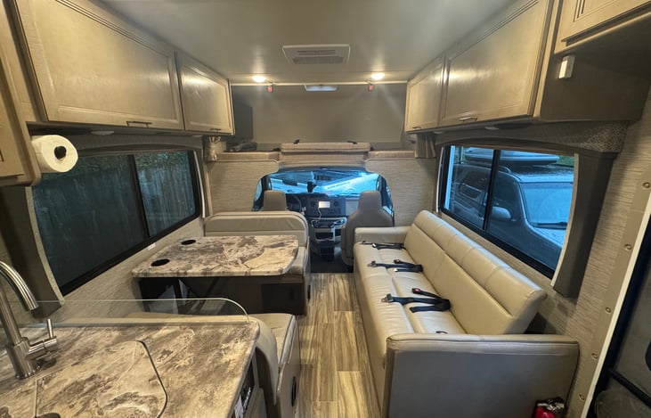 Seven seat belts in the RV. Two in front, three on the couch, one per dinette bench.