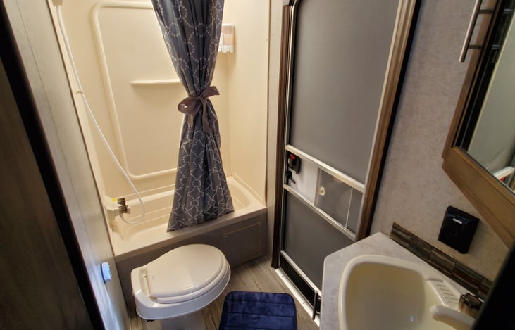 Bathroom has a rear entrance door.