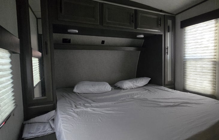 Separate Master Bedroom with King sized Bed.  1 door to go outside, 1 door to go into kitchen, and another door into the bathroom.