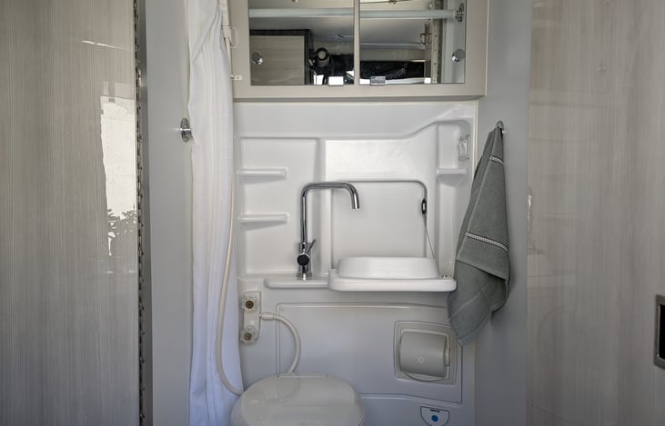Bathroom with sink, mirror and cabinet for toiletries