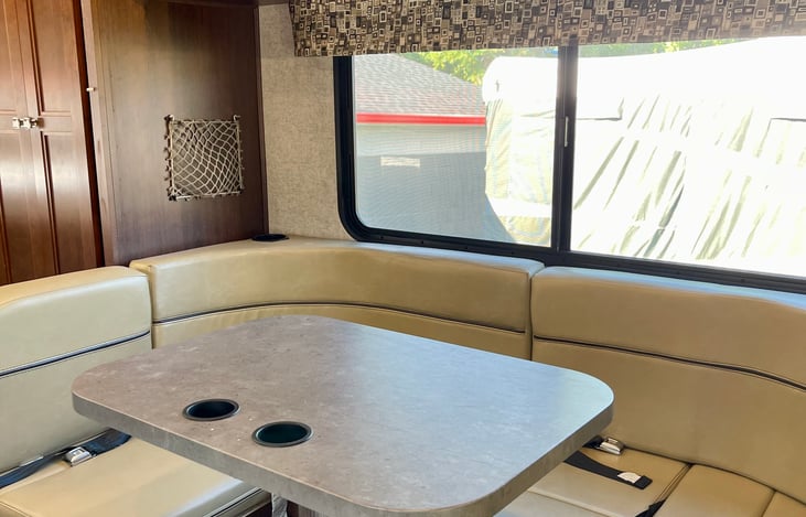 Dining area, 4 seat belts available (kids love playing cards here during the drive), converts into a bed.