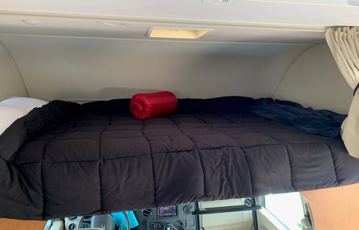 LOTS of room over the cab bunk. 2 Adults or 3 small kids.