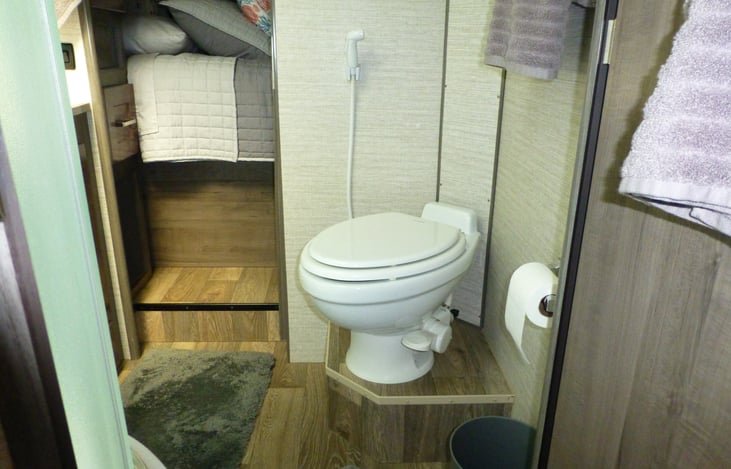 Upgraded porcelain bathroom commode.