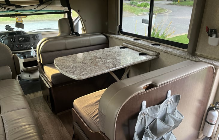 Dining area - also converts to a bed.
Comfortable thick cushions.
Lots of overhead storage runs along both sides of the main cabin