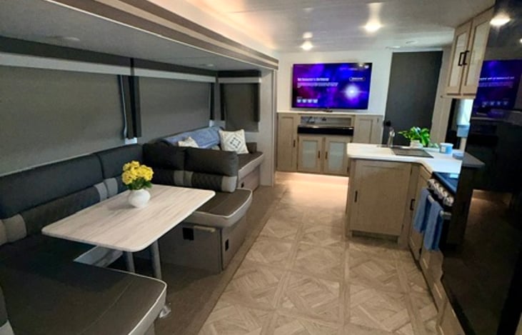 Separate eating area with led lighting inside. Both table and couch convert to sleeping quarters.