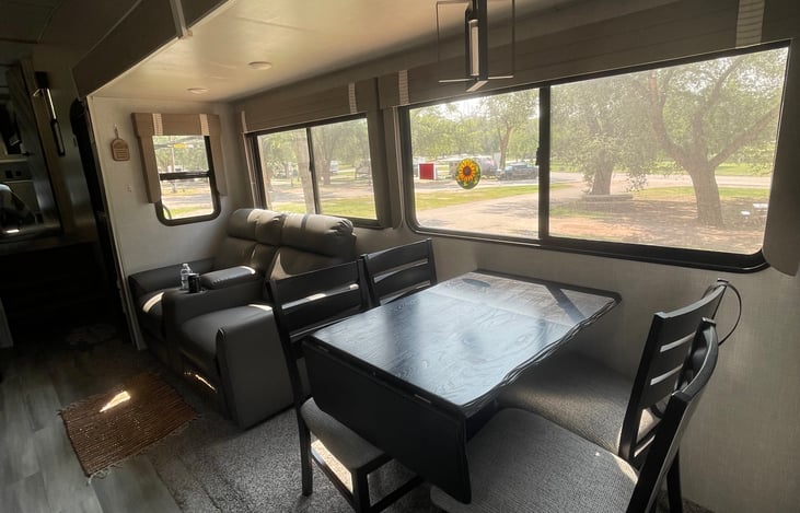 View of dining ar4ea and recliners and all those beautiful windows.