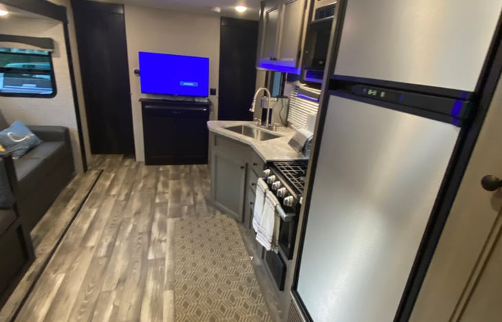 TV, kitchen and tri-fold sofa for comfort