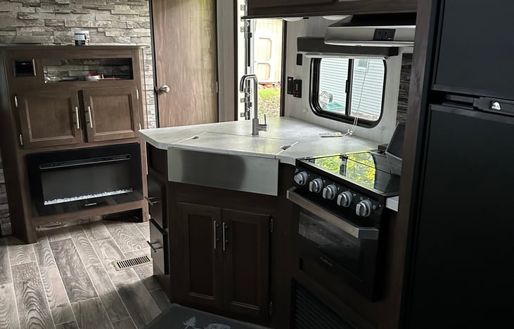 Gas range, oven, microwave, fridge/freezer, sink and electric fireplace