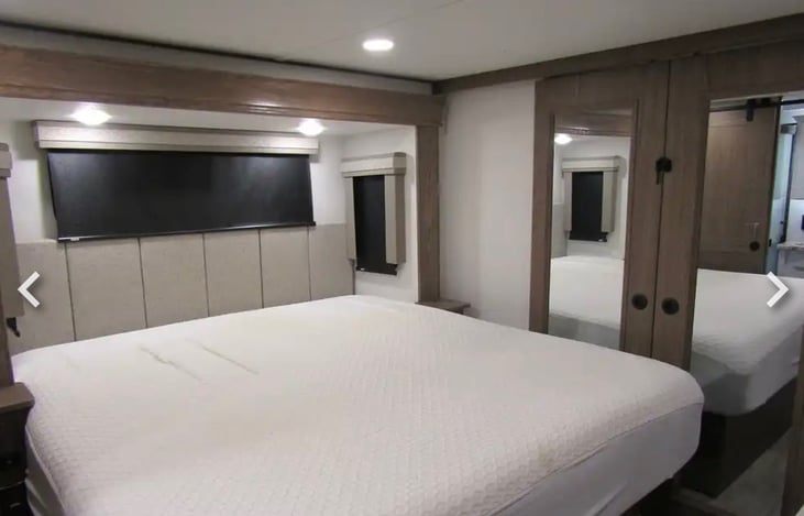 Primary bedroom with king bed (linens will be included, pictures taken before linens were put on bed)