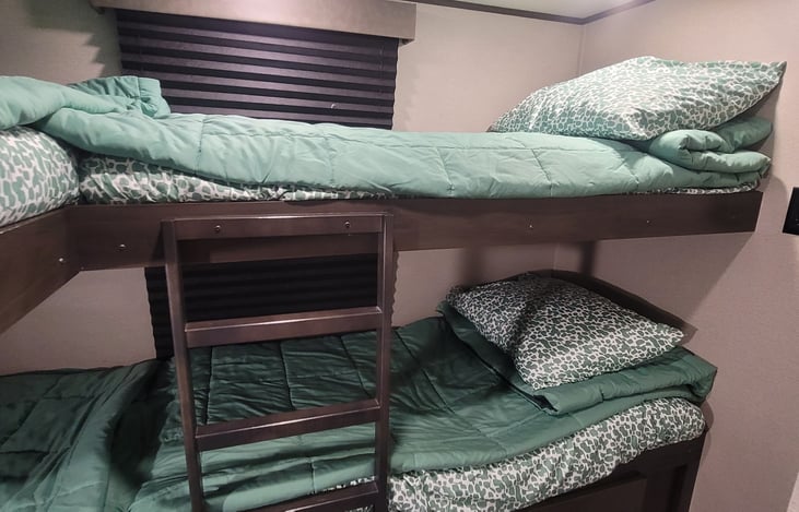 Bunk house has 4 beds, 4 large drawers, 2 small drawers, shoe cubby, and a small closet with hanging space.