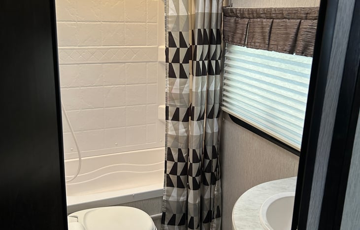 bathroom with toilet paper and linens