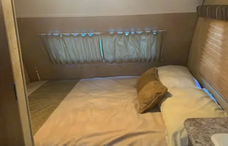 Cozy permanent queen-size bed located in the rear cabin section.
