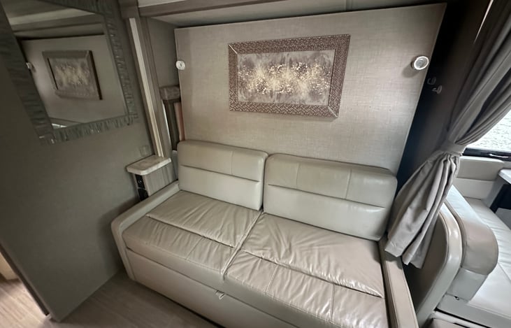 Sofa with storage and queen bed behind the wall