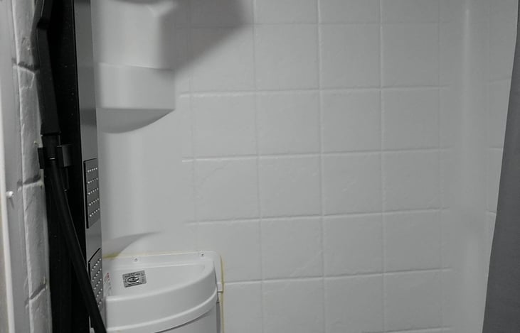 Shower comes with a sink to wash your hands and brush your teeth.