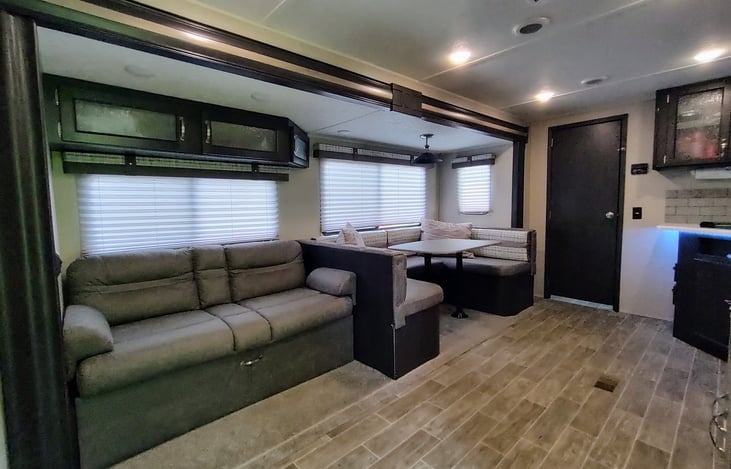 Living, dining and kitchen view from main entrance to camper.