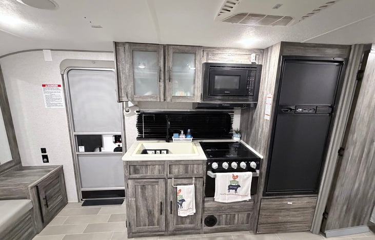 Kitchen with stove/oven and microwave. Fridge and freezer are ice cold.