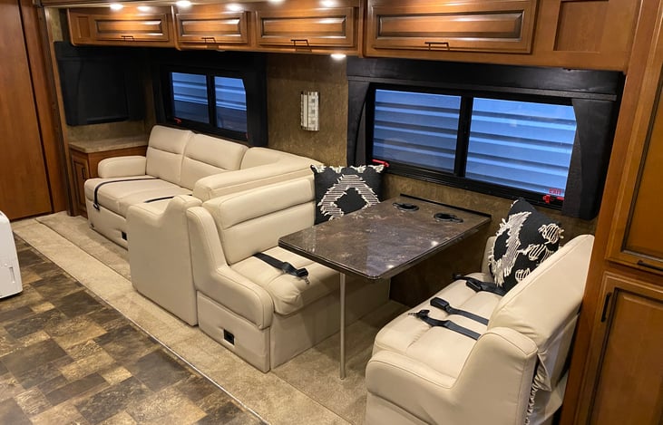 Dinette and couch. Two seatbelts on couch, four at the dinette. The couch extends to create the "L-Shape" in front of a fireplace (not pictured). Fireplace is electric.