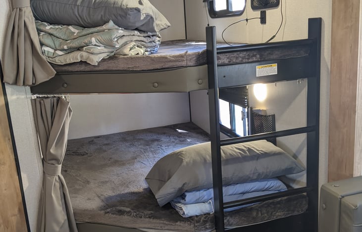 Almost full bunks with bedding.