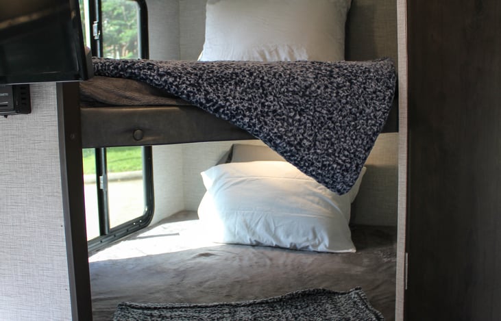 Don’t let these bunks fool you, ours are very spacious, they are wide twins that fit most adults comfortably! We provide pillows & bedding with our stays. If you have any questions please reach out!