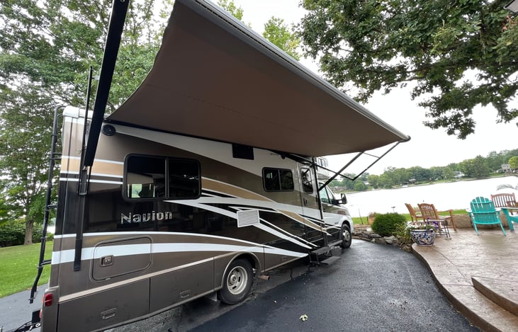 Outdoor awning with built in lights …we also provide string lights, camp chairs, camp stove w/gas canisters, outdoor rug, outdoor coffee table, cooking essentials, cleaning