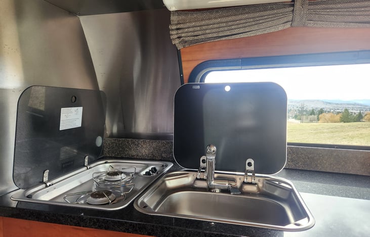 Sink and stove covers fold down for more counter space when not in use.