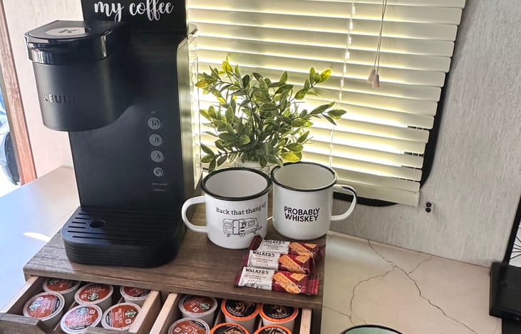 Keurig coffee maker with coffee pods and mugs