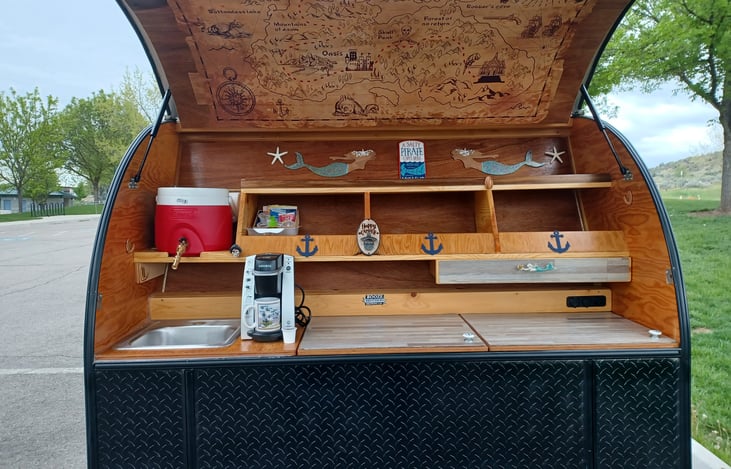 Beautiful outdoor galley with sink, fridge and USB ports and 12 volt plugs running off solar. Also 120v  and a Keurig Coffee Maker if your plugged into shore power.