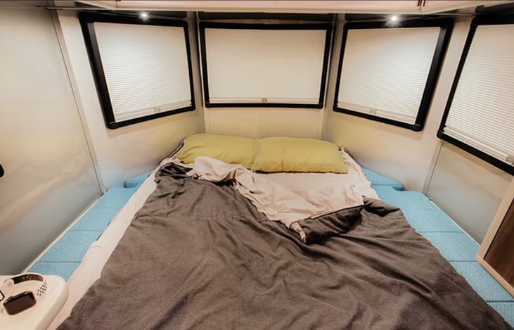 Large oversized king bed in back. Blackout shades (also open and have screens). Plenty of room for two plus a normal sized pet (Charis sleeps back here with me).