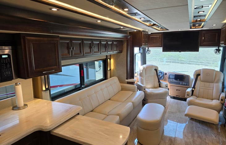 Driver and passenger seats turn around and recline when the bus is parked.  Passenger seat has a built in foot rest