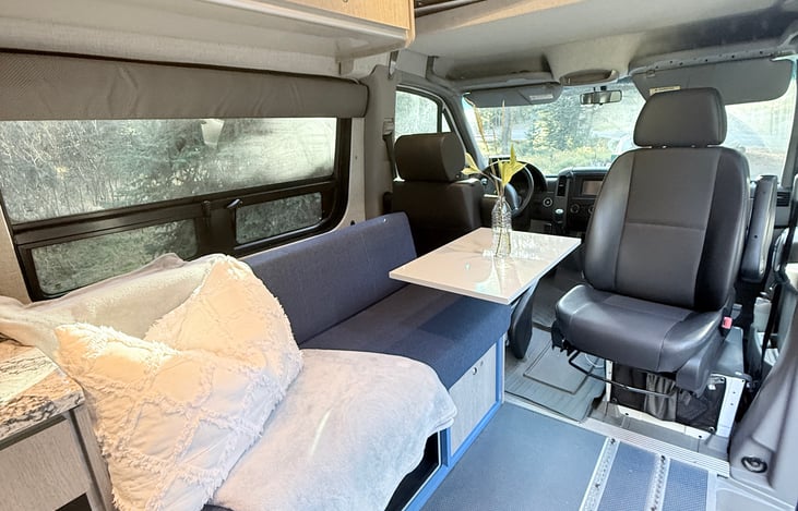 Passenger seat flips to the back. Bench seat with telescoping lagoon table.